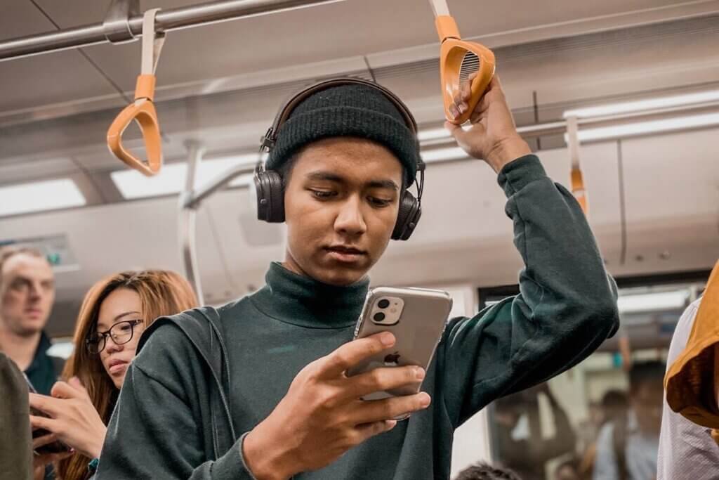 people on a train using their phones
